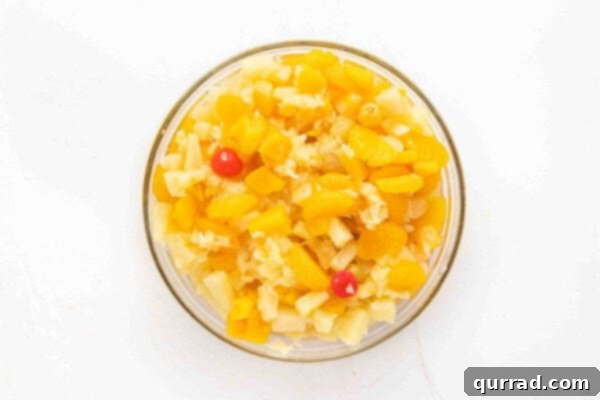 Variety of canned fruits draining in a bowl.