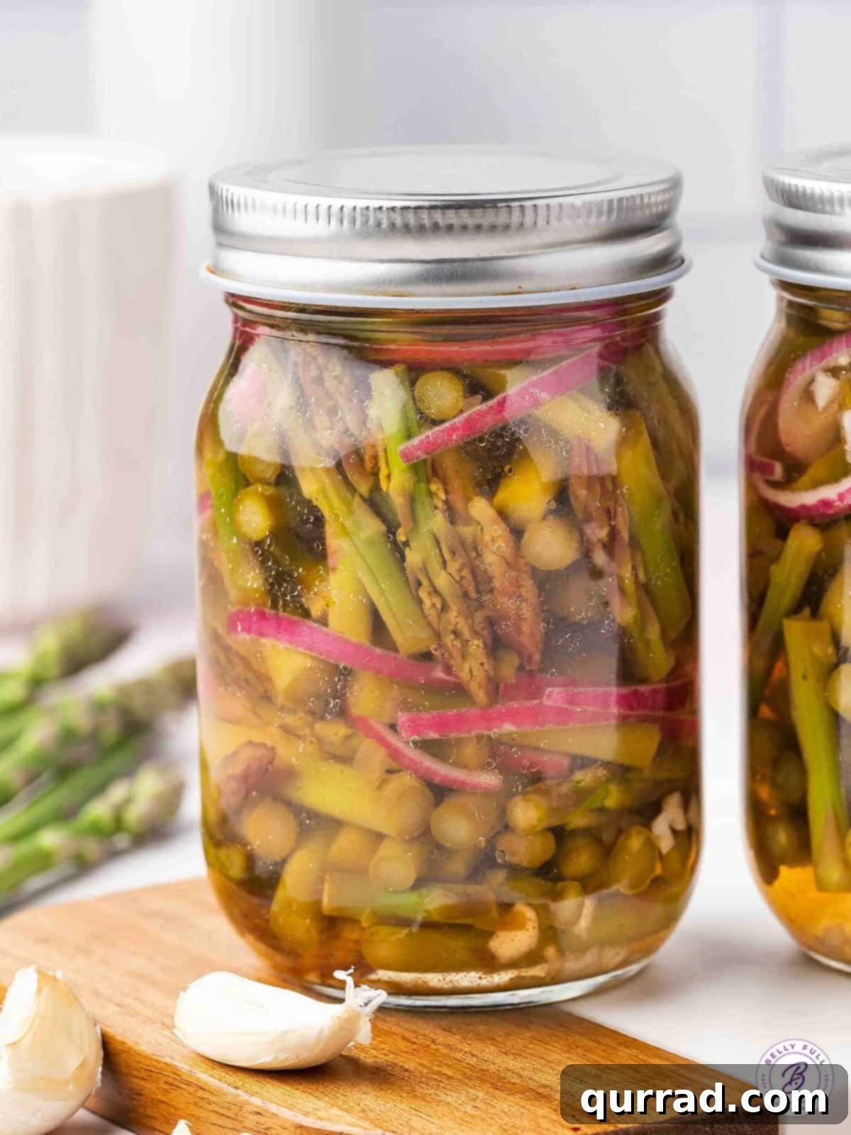 Fresh asparagus and onion are quick-pickled in a tangy and slightly spicy mixture in this Pickled Asparagus recipe. A jar of pickled asparagus