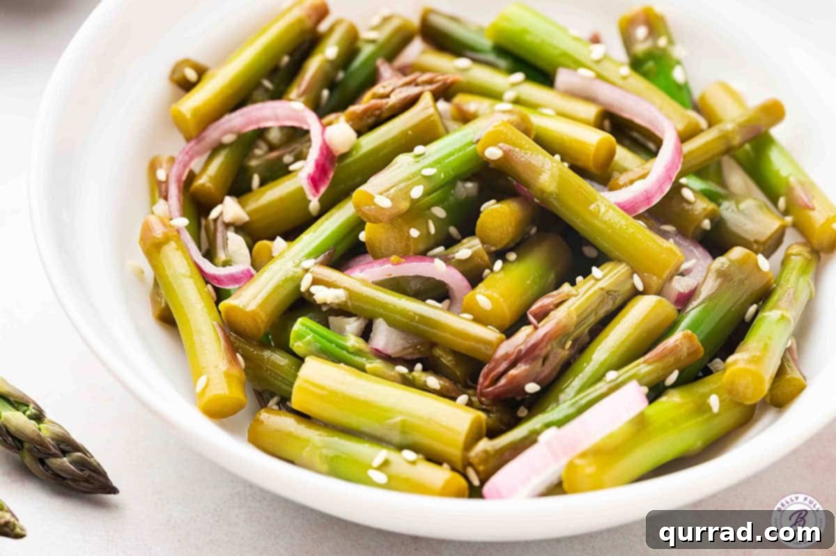 Fresh asparagus and onion are quick-pickled in a tangy and slightly spicy mixture in this Pickled Asparagus recipe. A plate of pickled asparagus salad