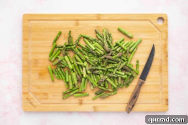 Pieces of asparagus on a cutting board