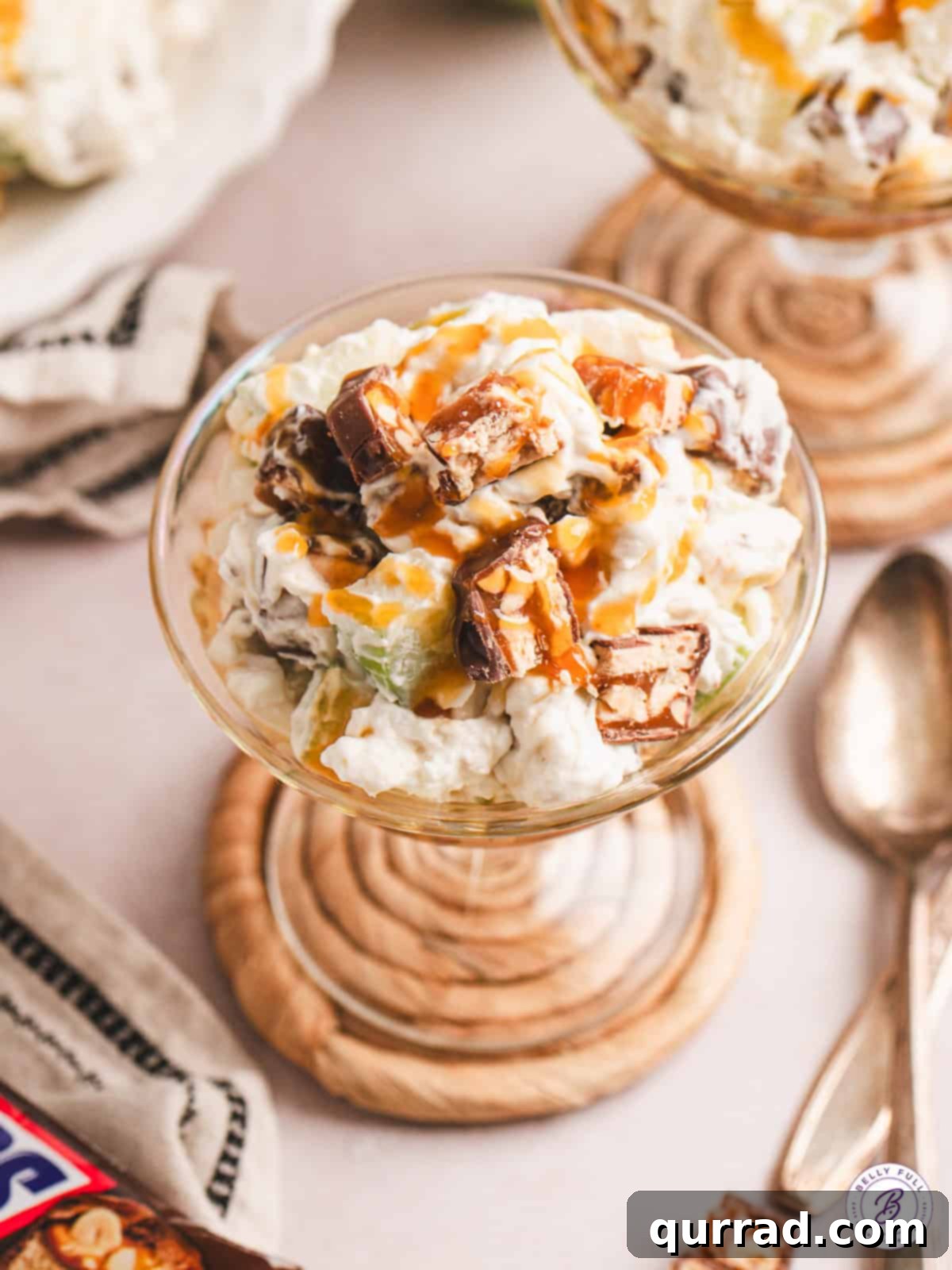 Soft Snickers, crunchy apples, and a sweet-but-tangy whipped cream cheese combine in this Snickers Salad. An easy summer dessert! A dessert cup of Snickers salad