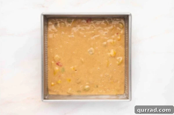 Cuppa Cake Delight 6 Smoothly spread Cuppa Cuppa Cake batter in a square baking pan, ready for the oven.