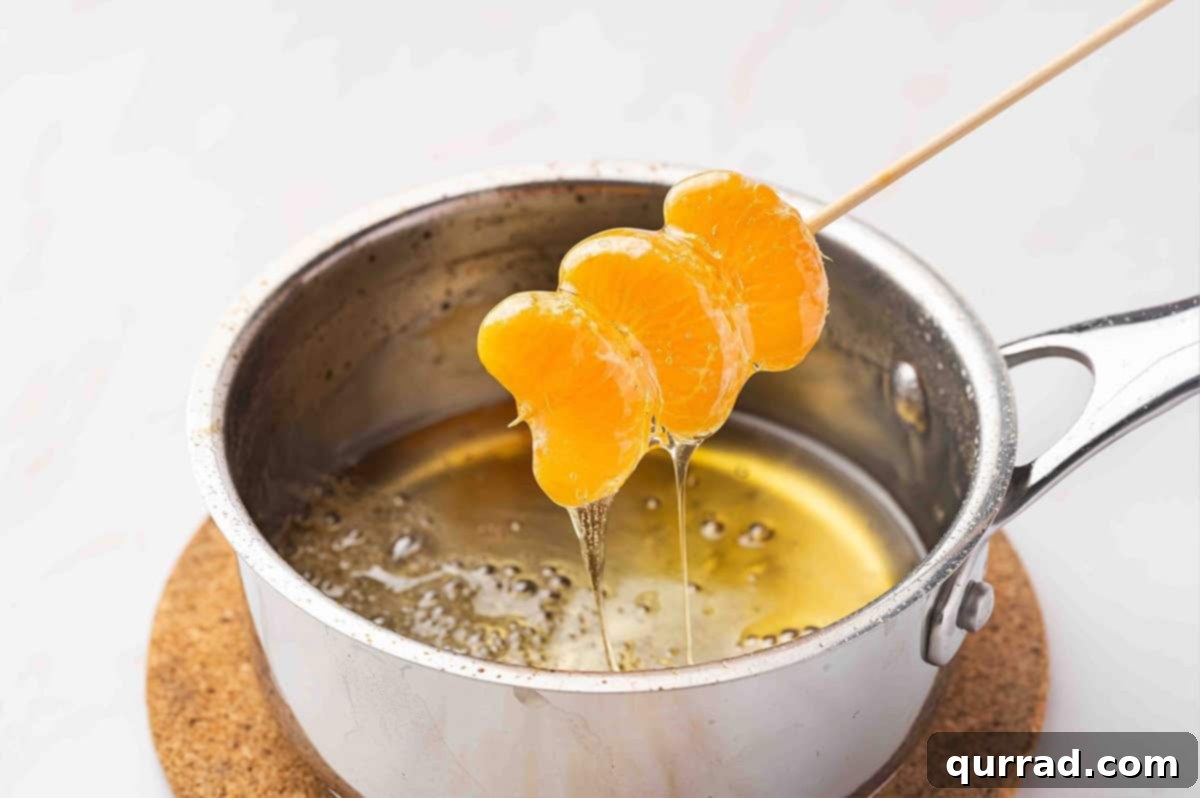 Letting sugar water drip off mandarin tanghulu