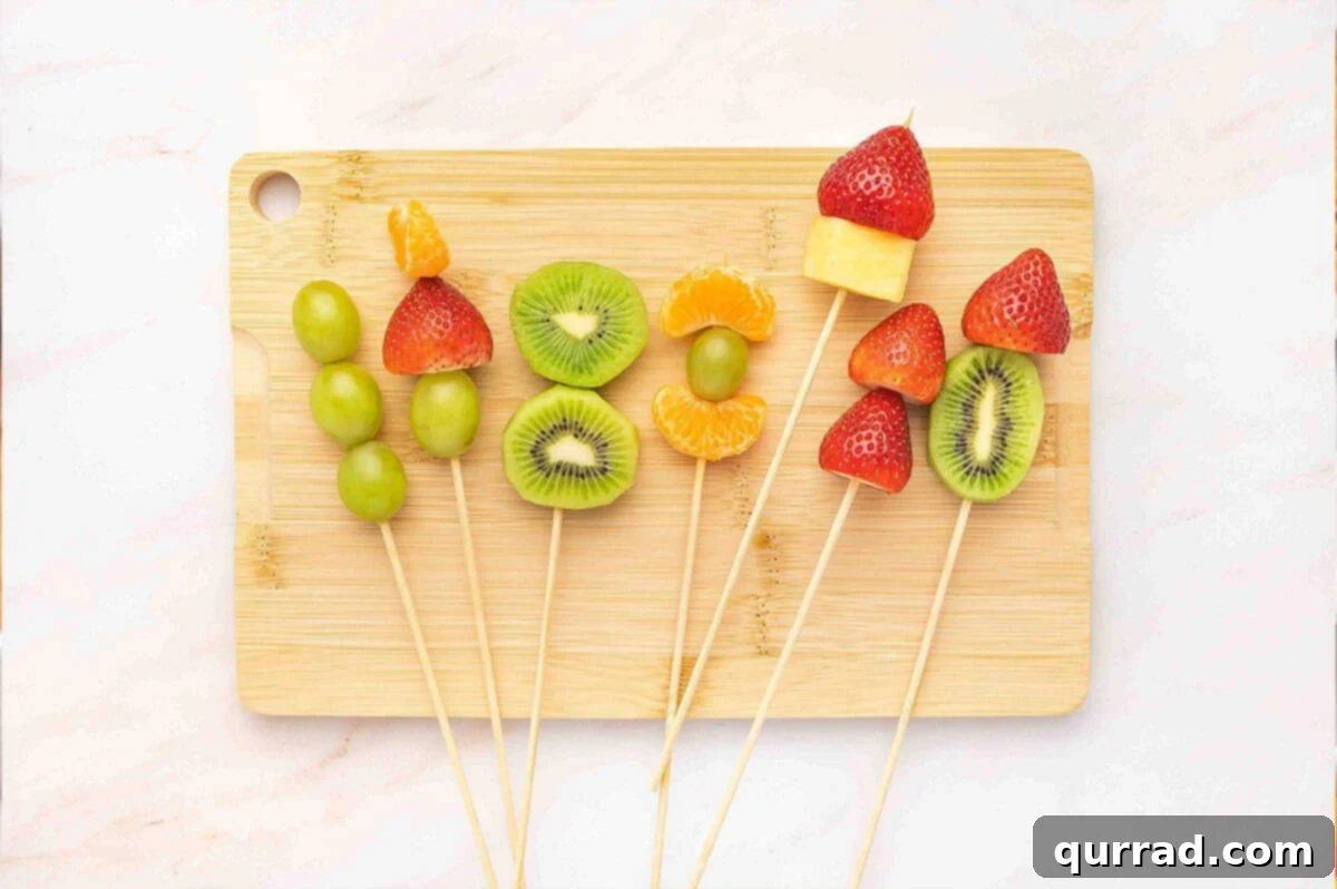 Fruit skewers on a wooden cutting board