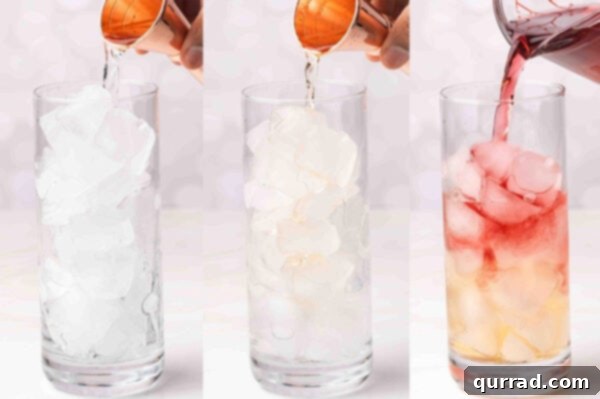 A close-up shot of ingredients being poured into a cocktail glass: vodka, peach schnapps, and cranberry juice.