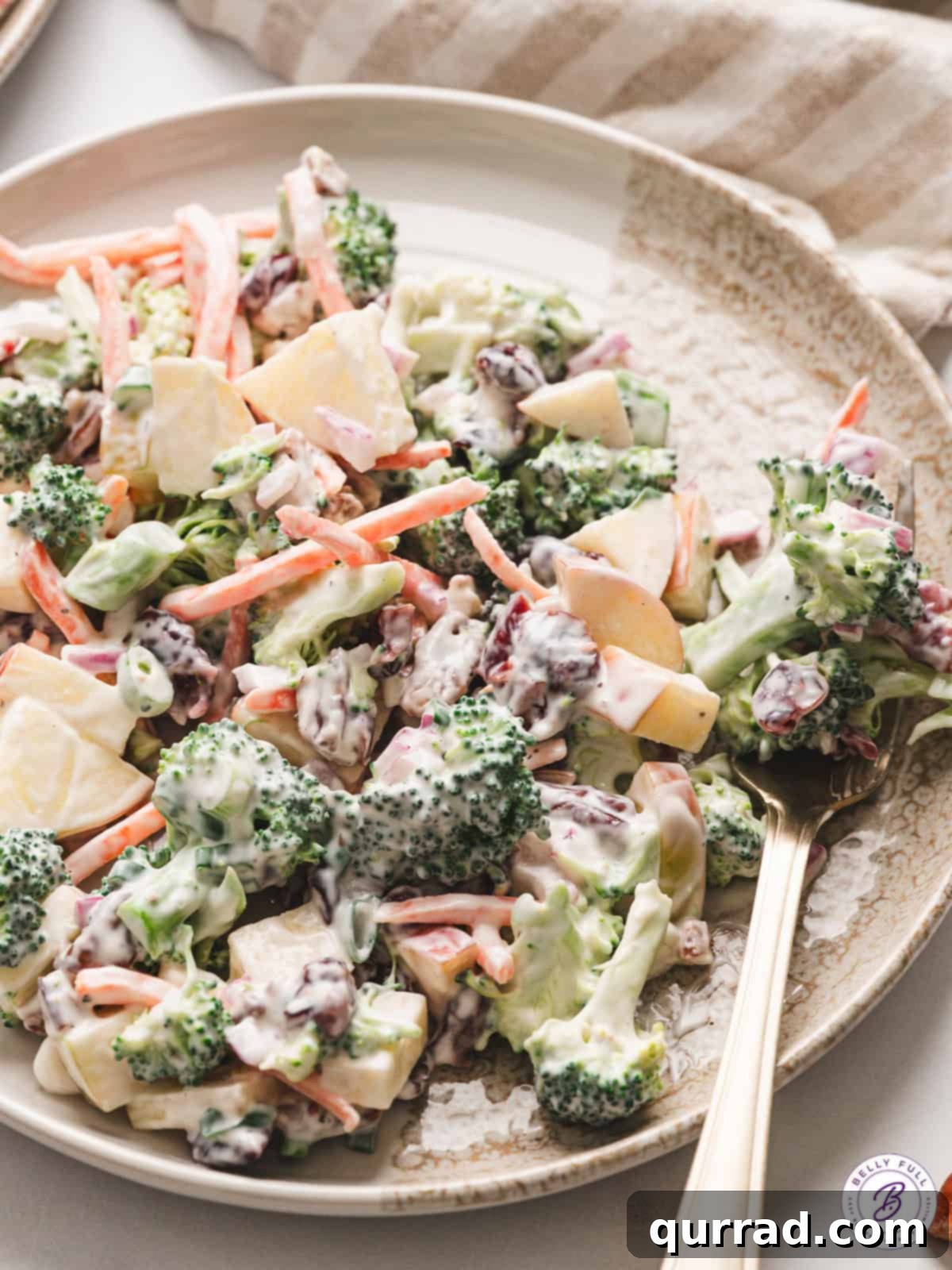 A beautifully presented plate of vibrant Broccoli Apple Salad, garnished and ready to be enjoyed, with a focus on its fresh, crisp appeal
