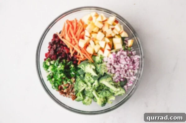 Diced veggies and apples in a bowl ready for dressing