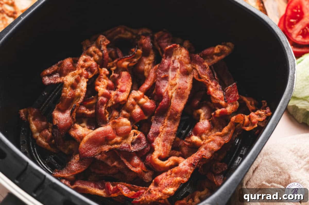 Crispy Air Fryer Bacon Perfection 6 Several strips of cooked, crispy bacon beautifully arranged in the air fryer basket.