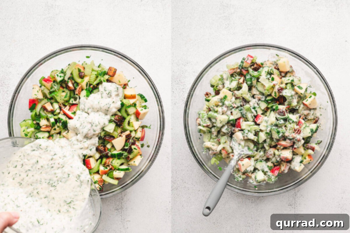Thick, creamy parmesan dressing being poured over the colorful Apple Date Celery Salad ingredients in a large bowl, preparing for a final toss.
