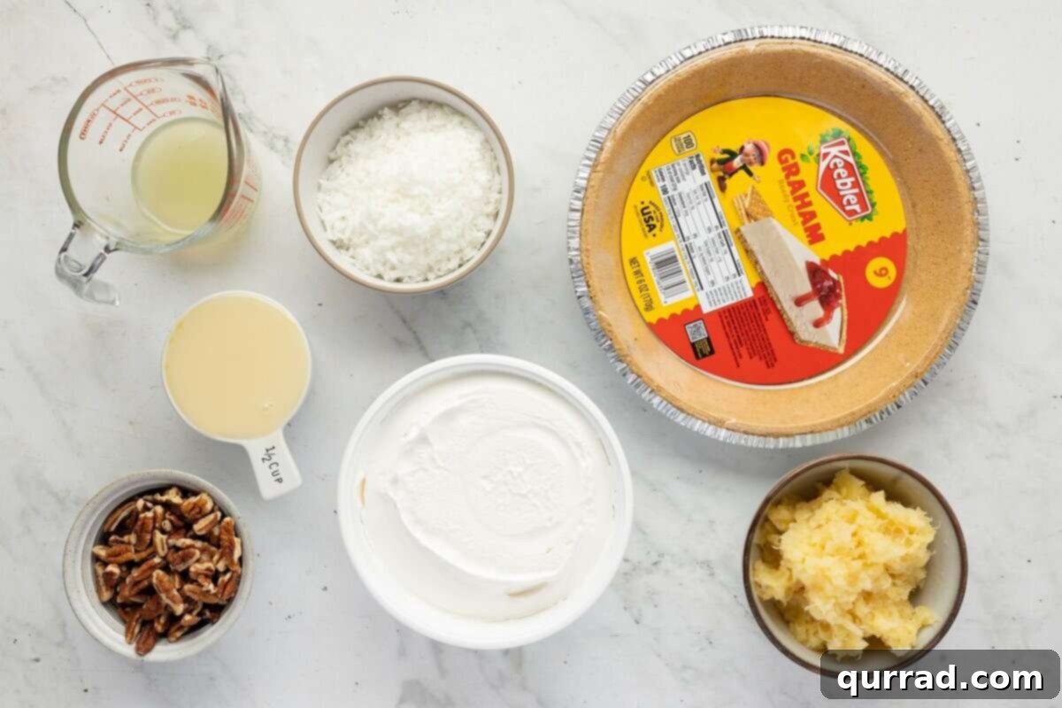 Ingredients for Million Dollar Pie laid out, including sweetened condensed milk, lemon juice, drained pineapple, coconut, pecans, and Cool Whip.
