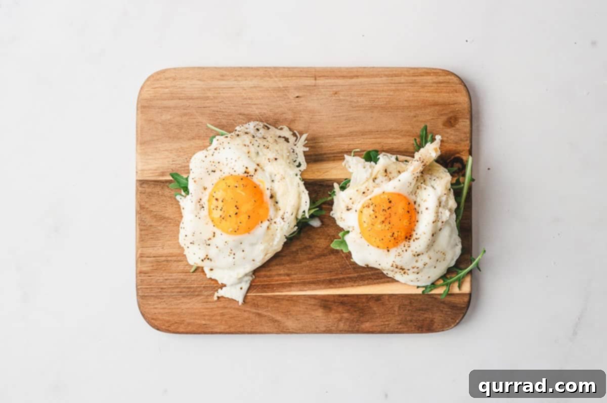 Crispy Cheese Eggs 9 Frico eggs served on a plate with a side of avocado slices and toast.