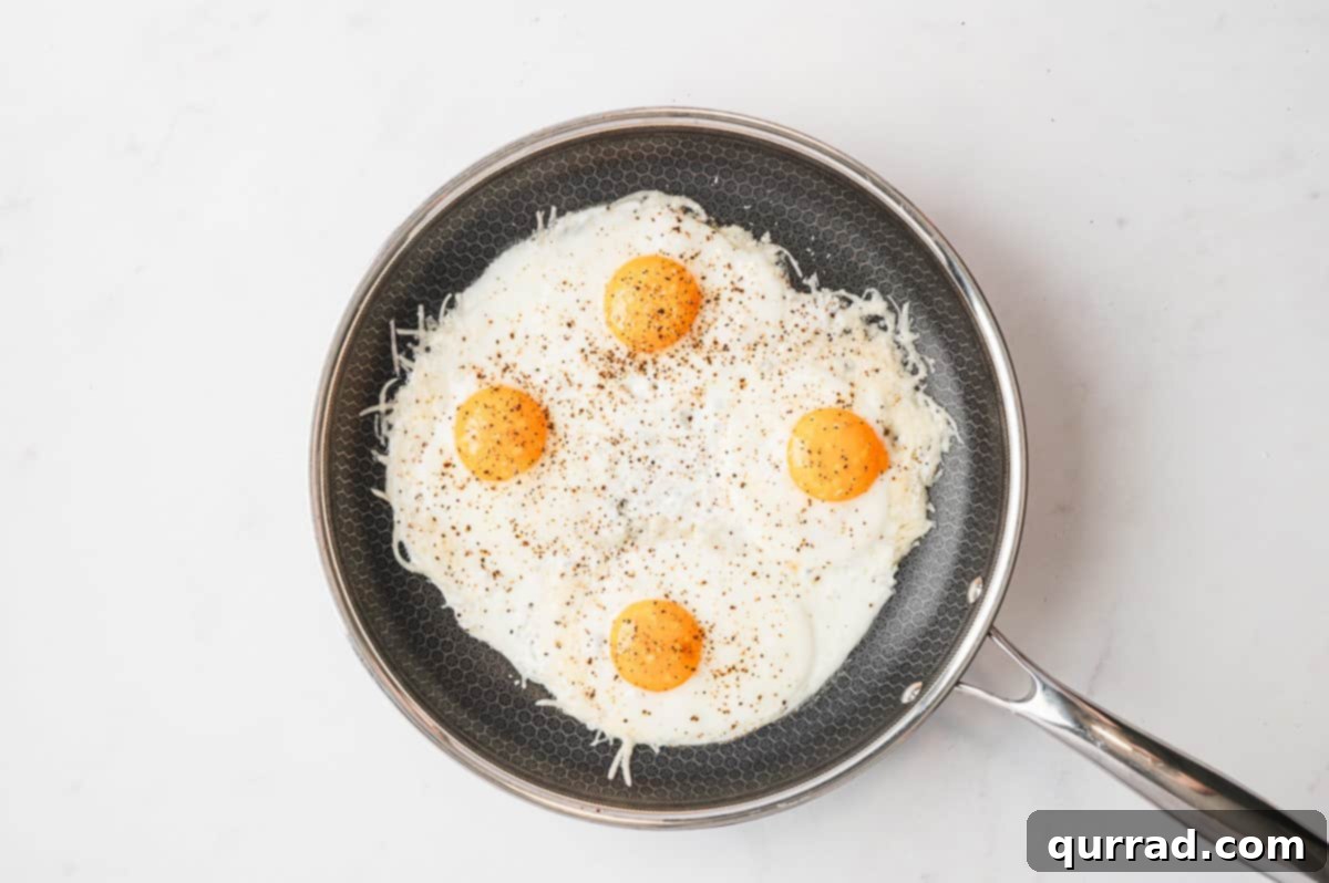Crispy Cheese Eggs 6 Eggs cracked into the center of each cheese nest in the skillet, cooking until set.
