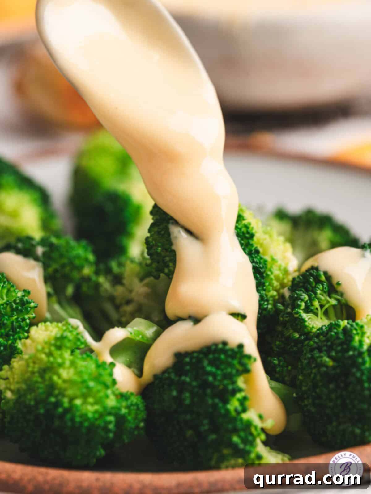 Liquid Gold Cheese 10 cheese sauce being poured over broccolie