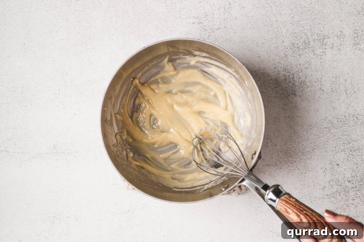 Liquid Gold Cheese 5 Flour and salt whisked into melted butter forming a smooth roux.