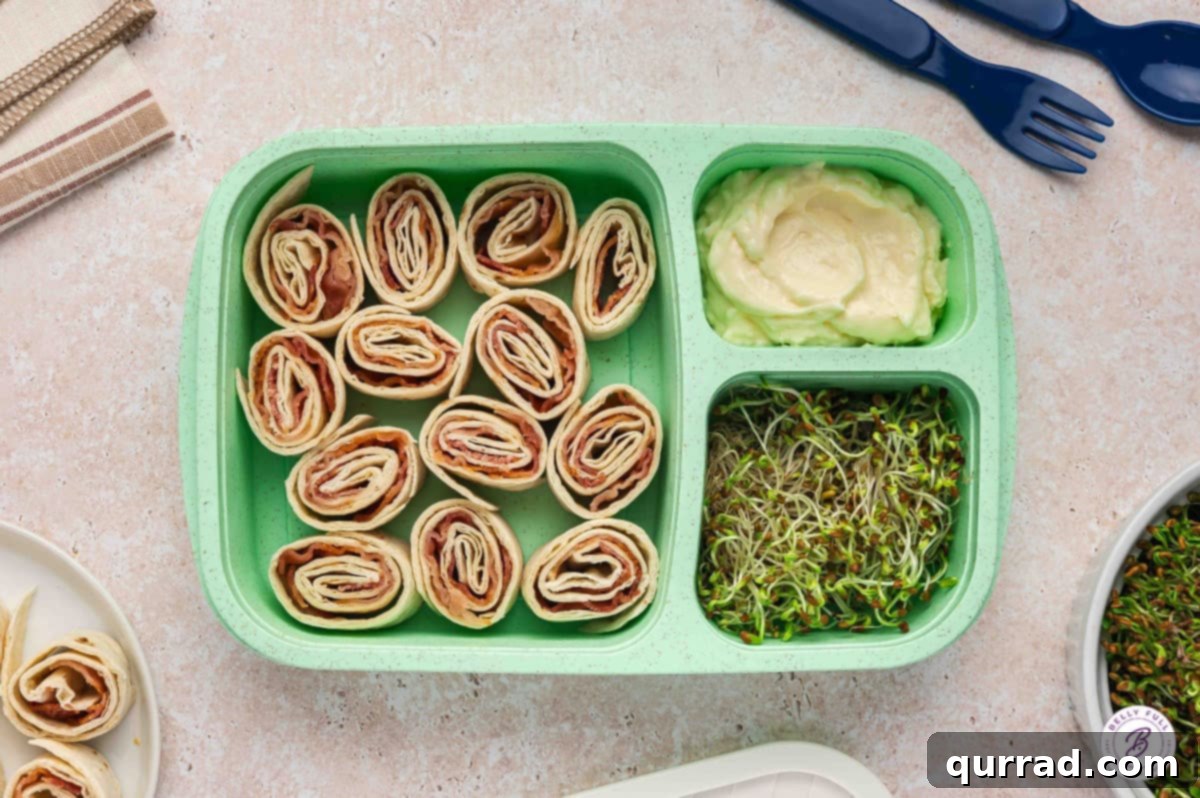 Delicious & Easy School Lunches 5 Bento box with delicious BLT pinwheels and a side of creamy mayonnaise for dipping.