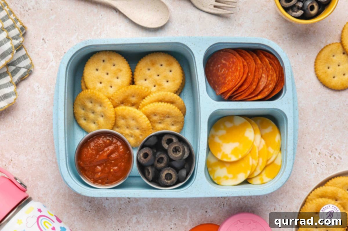 Delicious & Easy School Lunches 8 Build Your Own Pizza bento box with Ritz crackers, pepperoni, Colby Jack cheese, black olives, and marinara sauce.