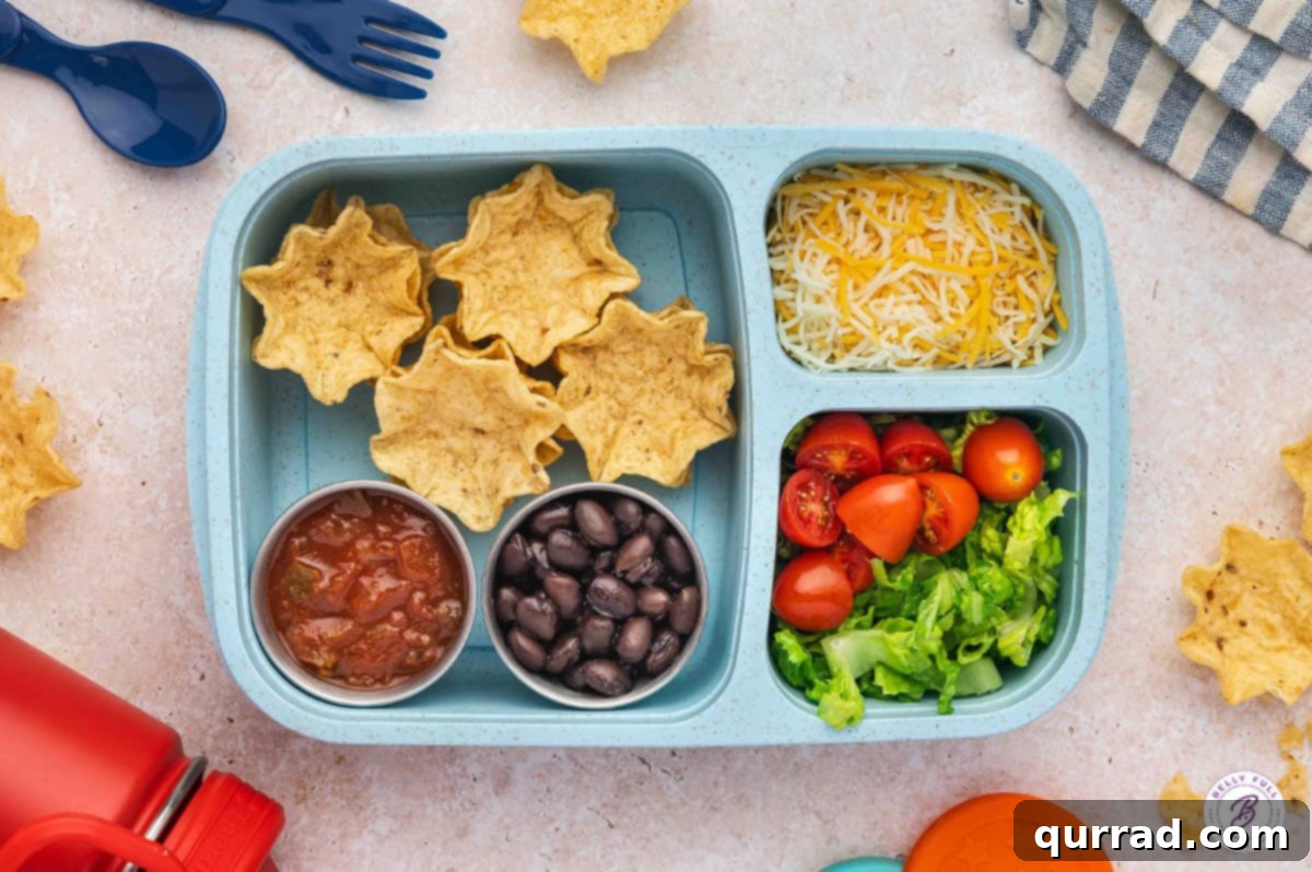 Delicious & Easy School Lunches 9 Build Your Own Taco bento box with tortilla Scoops, black beans, shredded cheese, diced tomatoes, and chopped lettuce.
