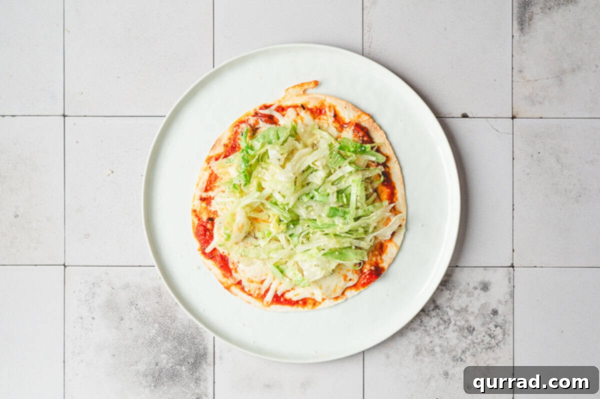 Pizza Garden Wrap 8 Air-fried cheesy tortilla topped with seasoned shredded lettuce before folding.