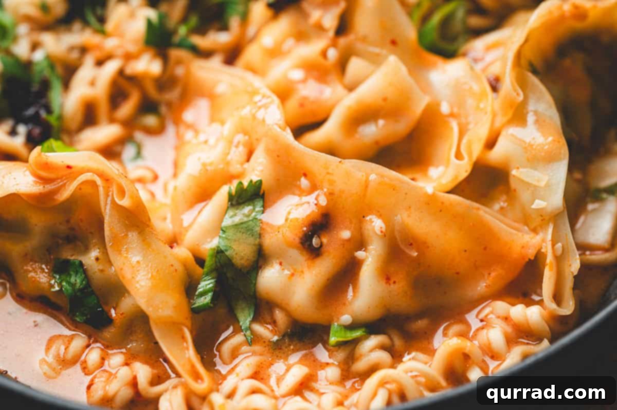 Thai Dumpling Oven Feast 9 A close-up, appetizing view of a single dumpling coated in the creamy Thai curry sauce, resting among tender ramen noodles and crisp cilantro. This detailed shot highlights the rich texture of the sauce and the fresh garnishes, making the dish irresistible.