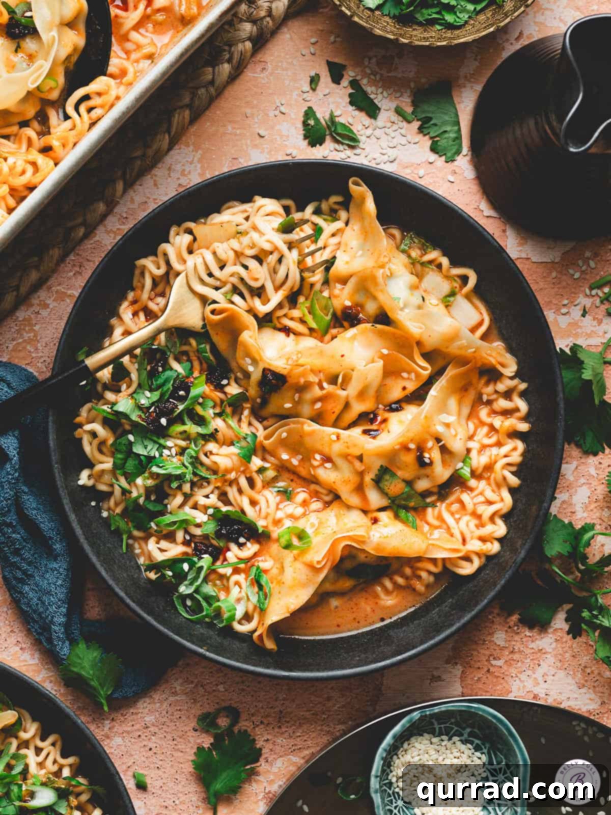Thai Dumpling Oven Feast 10 A vibrant and inviting image of the complete One-Pan Thai Dumpling Casserole, showcasing the rich curry sauce, tender ramen noodles, plump dumplings, and fresh garnishes of cilantro, scallions, chili crisp, and sesame seeds. The image promises a comforting and flavorful homemade Asian-inspired meal.