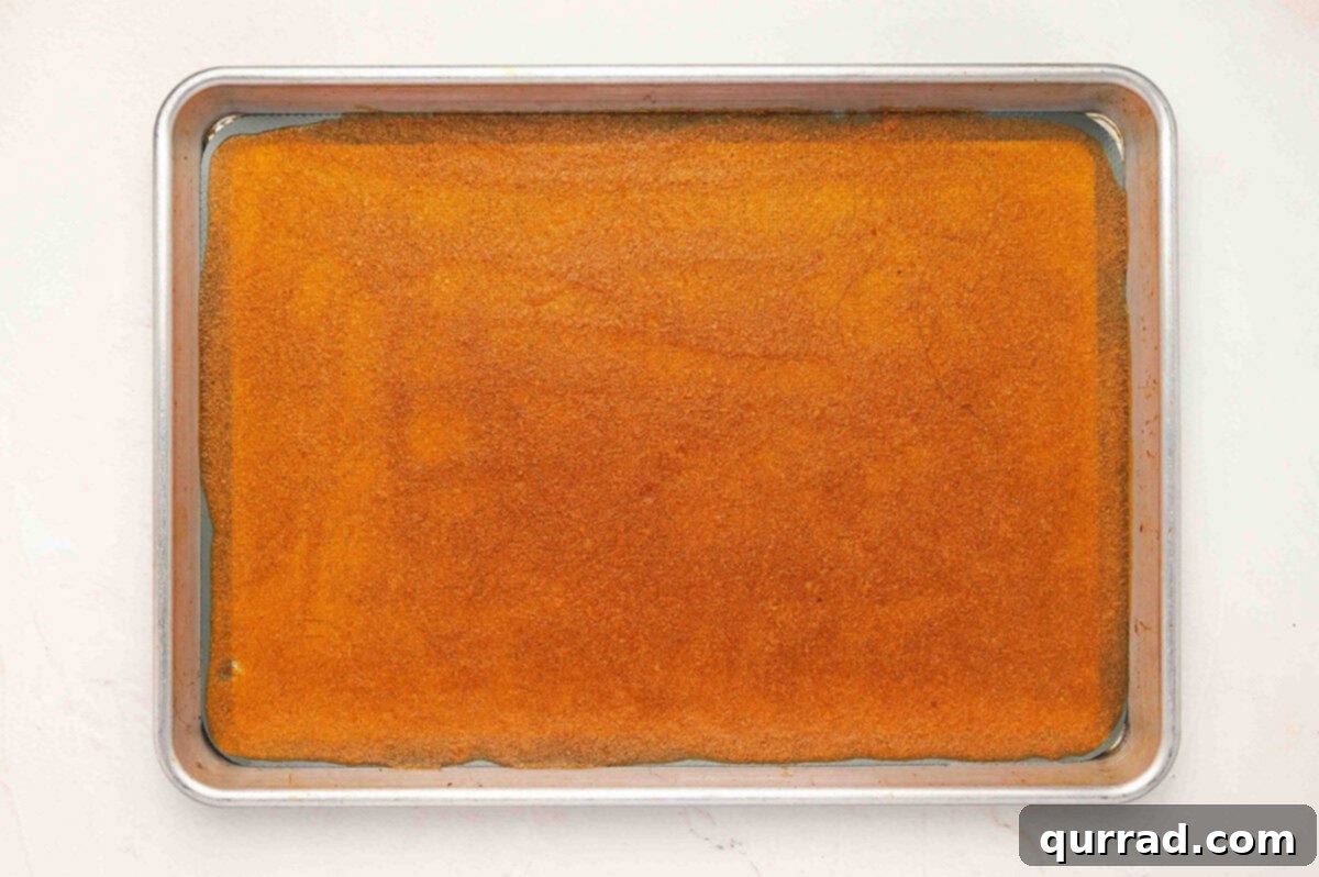 Fully baked apple fruit leather sheet on a baking tray, evenly dried and set.