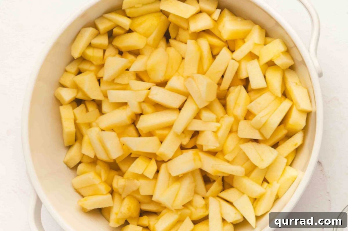 Bowl filled with peeled and chopped apples ready for cooking.