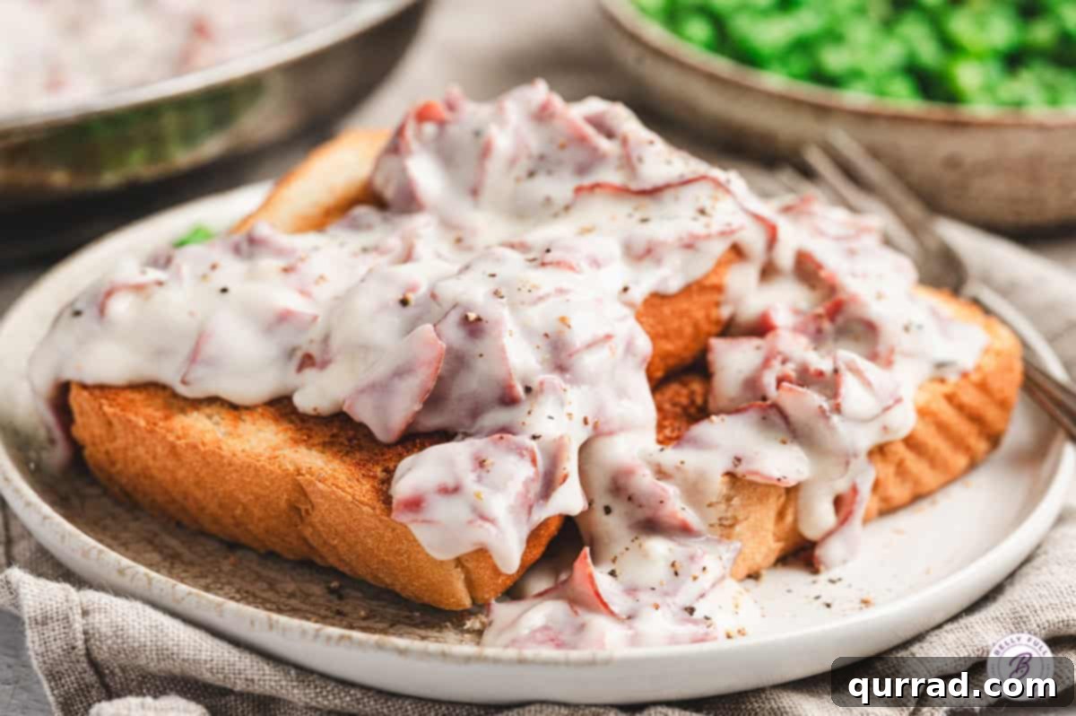 Savory Shredded Beef in Cream Sauce 8 Toasted bread slices covered in creamy chipped beef gravy on a plate, ready to serve.