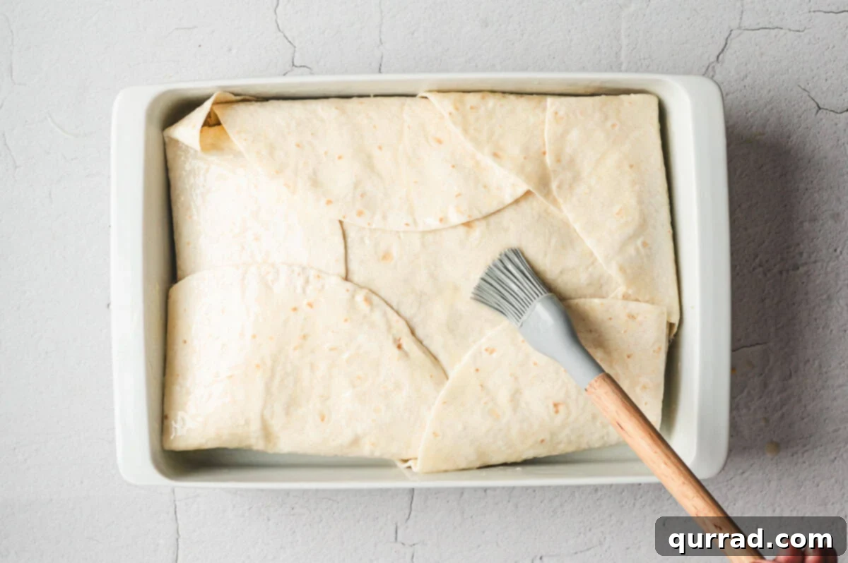 Casserole brushed with melted butter on top of folded tortillas before baking.