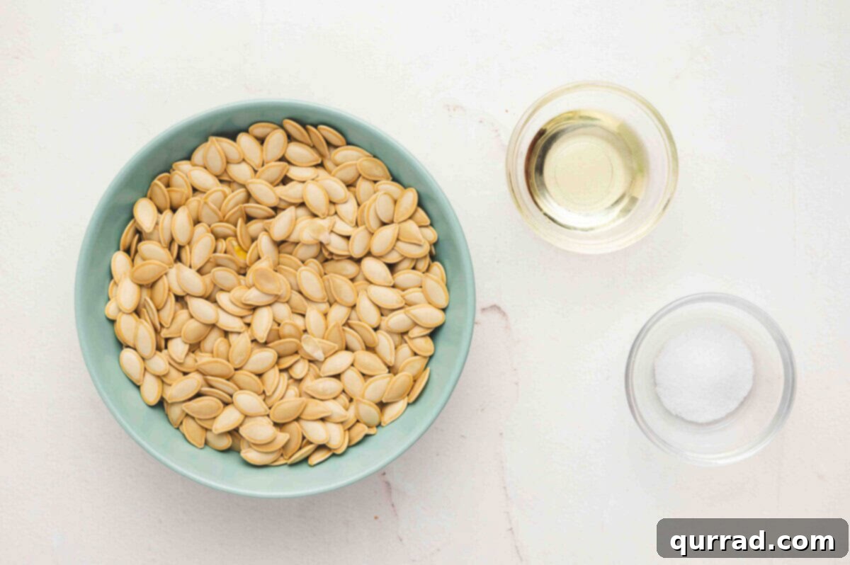All the essential ingredients for roasting pumpkin seeds laid out: raw seeds, olive oil, and coarse kosher salt.