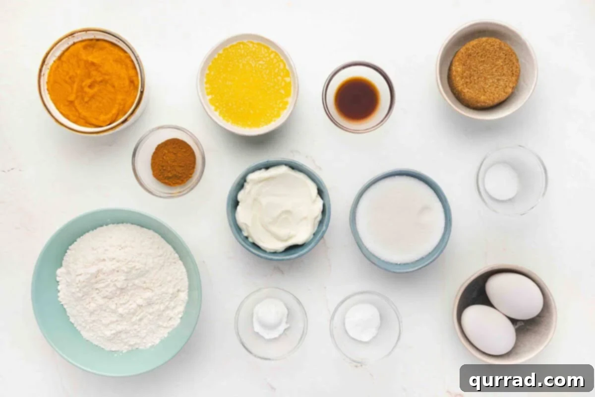Snickerdoodle pumpkin bread ingredients laid out on a kitchen counter, ready for baking.