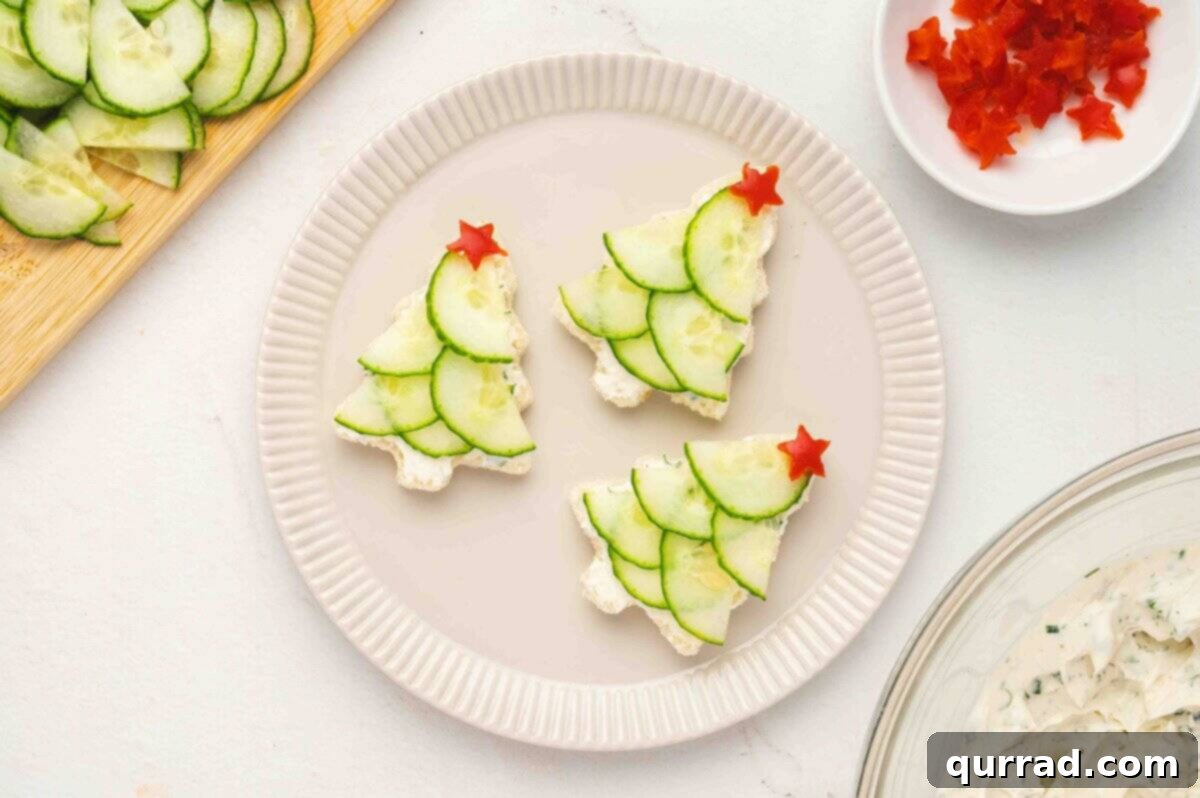 Christmas Tree Cucumber Bites 10 Finished sandwiches topped with red bell pepper stars arranged neatly on a plate
