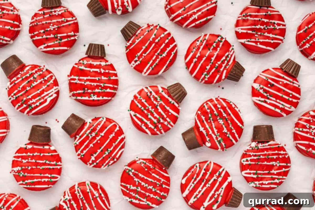 Ritz Cracker Holiday Charms 8 Assorted red chocolate-covered Ritz cracker ornament cookies drizzled with white chocolate and sprinkles, arranged on parchment.