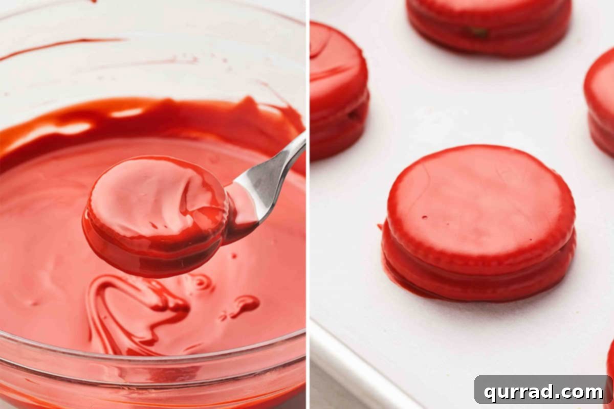 Ritz Cracker Holiday Charms 5 Ritz peanut butter sandwich being dipped into melted red candy coating and placed on a parchment-lined sheet to set.