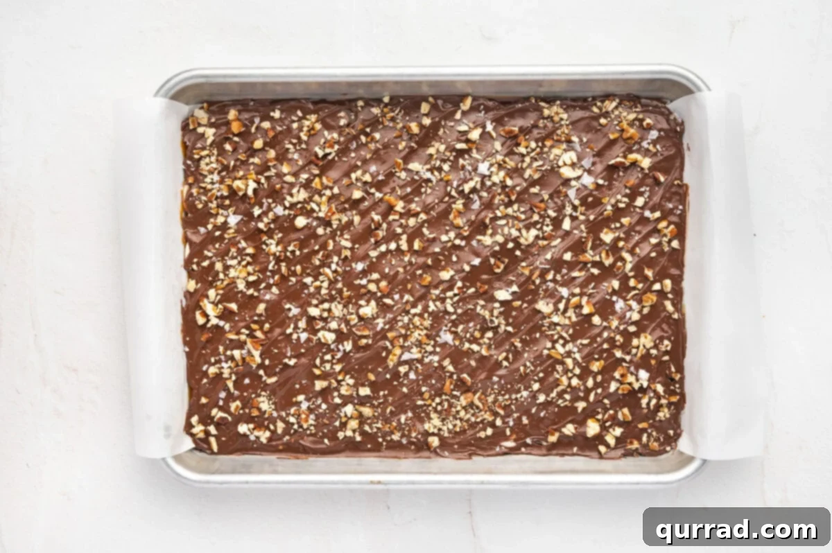Cool the toffee bark in the refrigerator until set. Toffee bark cooling on a baking sheet