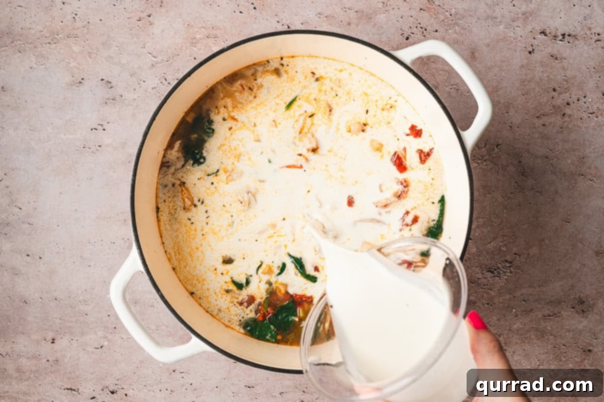 Marry Me Chicken Comfort Soup 10 Pouring heavy cream into the simmering soup