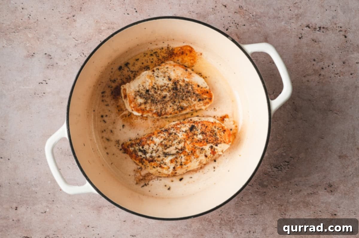 Marry Me Chicken Comfort Soup 4 Seasoned chicken breasts browning in a Dutch oven