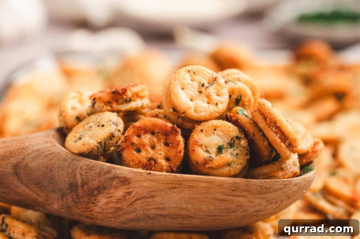 Garlic Bread Bites 10 Wooden scoop filled with golden garlic Parmesan Ritz Bits with more crackers blurred behind