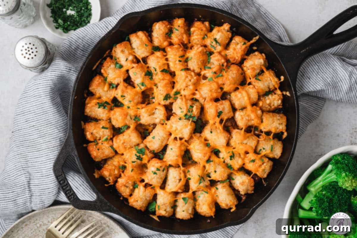 Baked sloppy joe tater tot casserole garnished with fresh parsley.