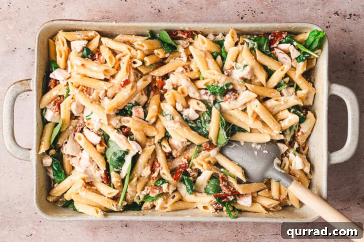 Oven-Baked Tuscan Chicken and Pasta 6 Stirring the Baked Tuscan Chicken Pasta