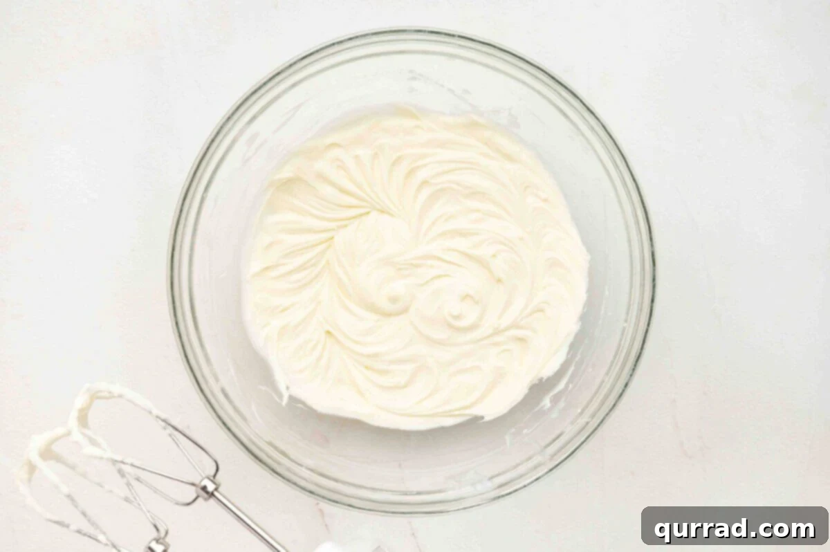 Whipped mascarpone cream in a glass bowl.