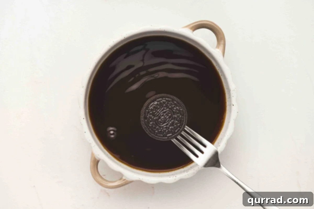 Dipping an Oreo cookie into the coffee mixture.