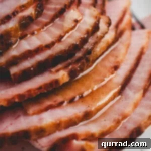 Sun-Kissed Pineapple Ham Glaze 3 A baked ham covered in pineapple ham glaze.