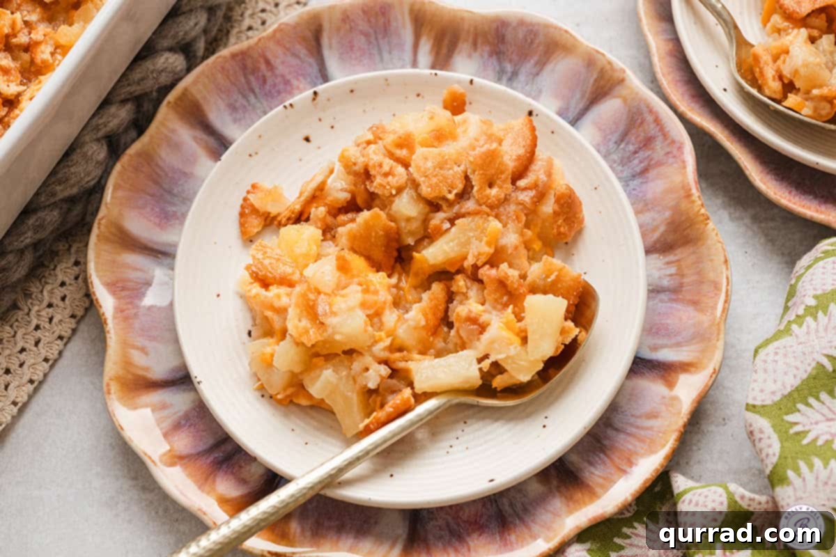 Pineapple casserole on a plate with a spoon.