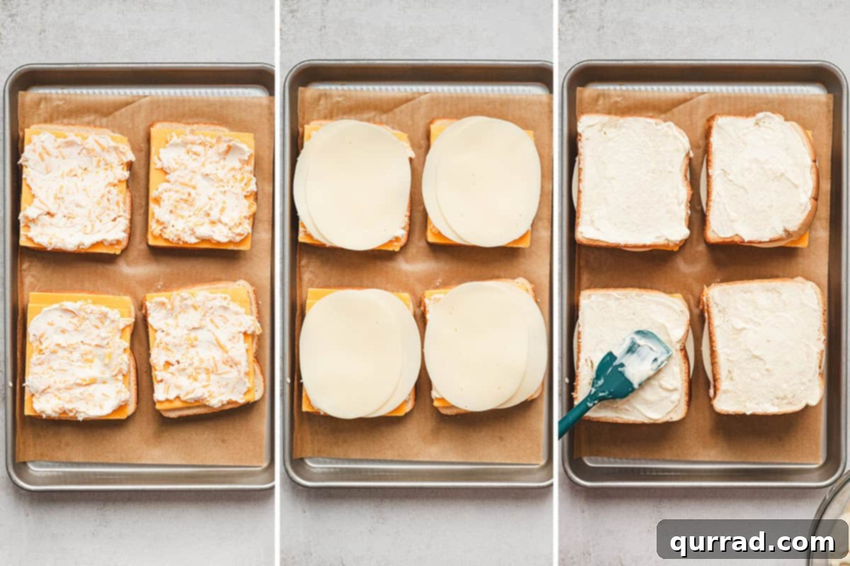The Happiest Grilled Cheese on Earth 8 Sliced cheese on Texas toast topped with a cream cheese mixture, followed by provolone cheese added to the bread, followed by a mayonnaise mixture being spread over the outside of the sandwiches.