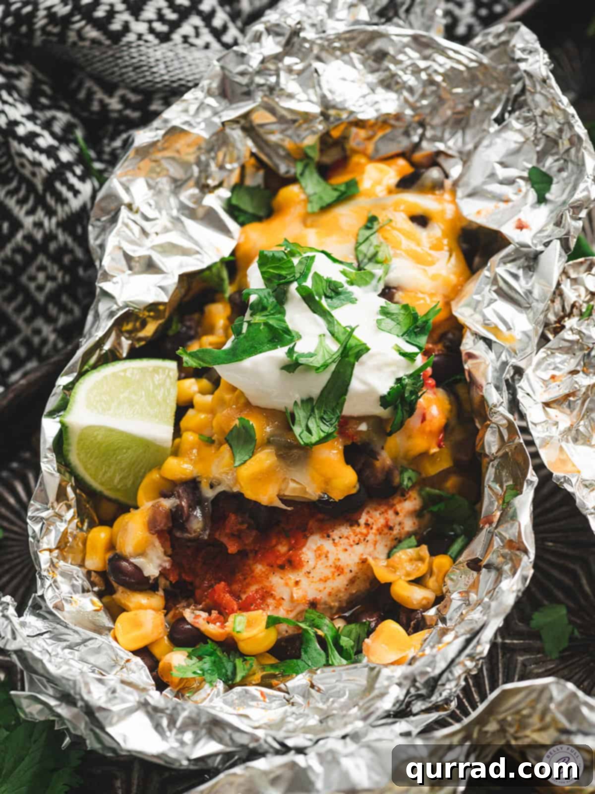 A Southwestern Chicken Foil Packet with lime, ready to be served.