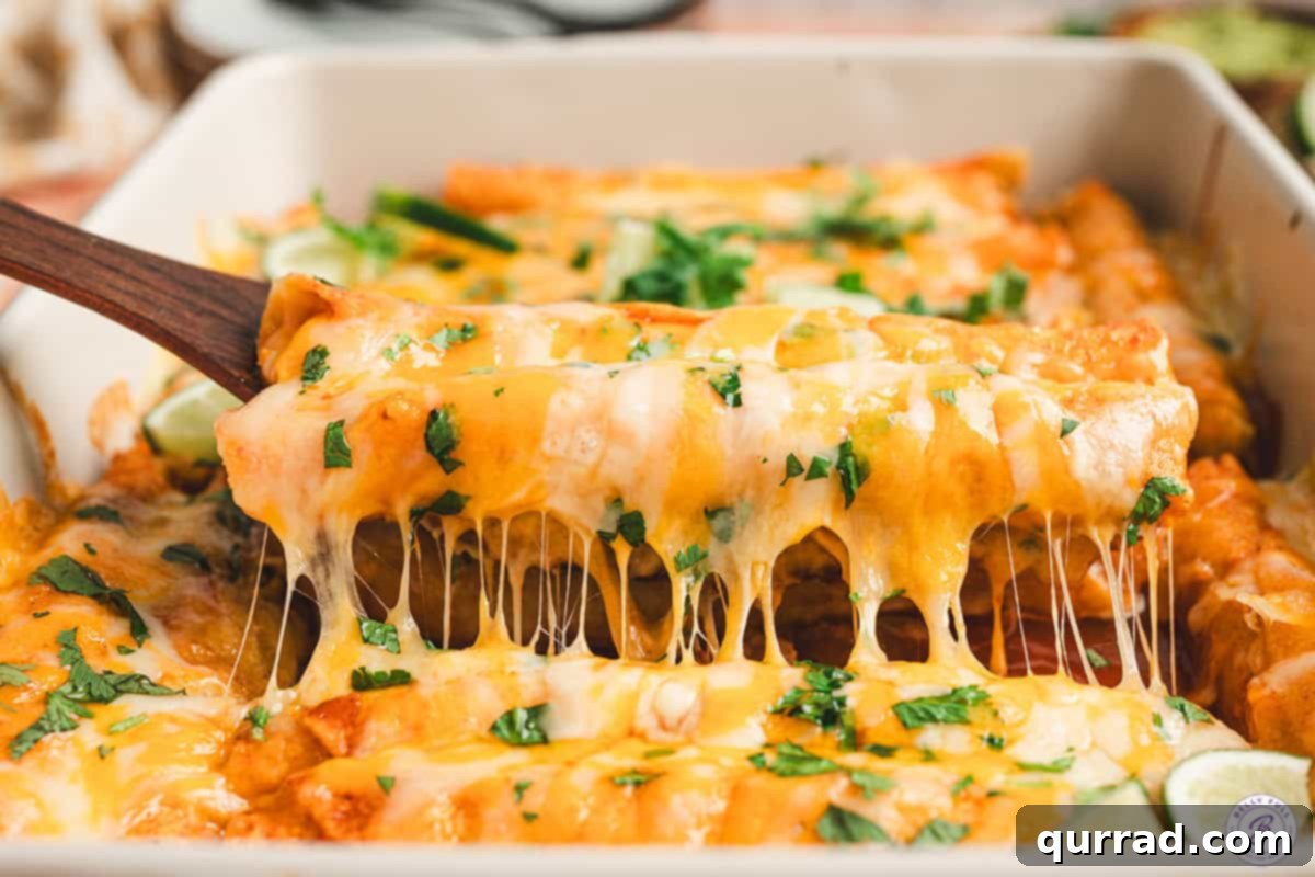 Effortless Enchilada Bake 10 A spatula lifting a portion of cheesy, saucy lazy enchiladas out of the baking dish, ready for serving.