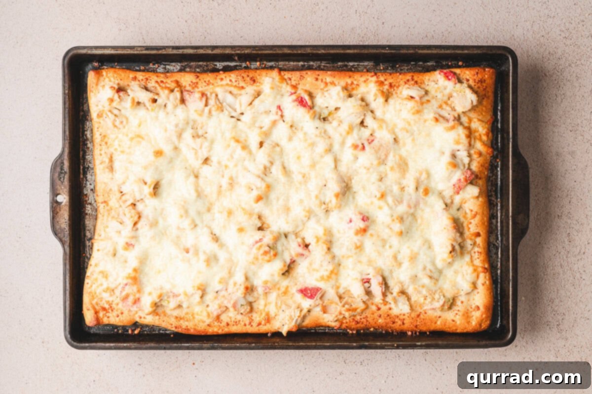 Crab Rangoon Pizza Delight 7 Golden baked crab rangoon pizza fresh from the oven with bubbly melted cheese.