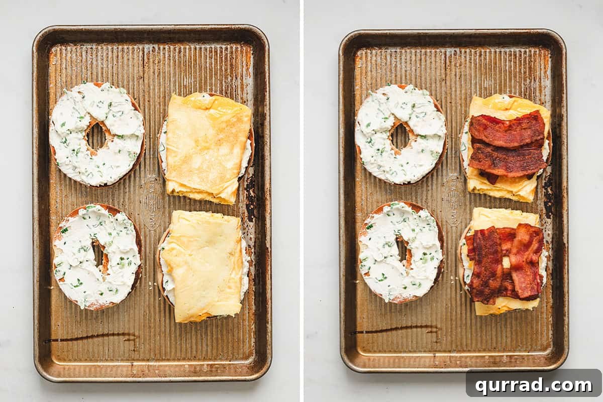 Assembling bee sting bagels with cream cheese, eggs, and crispy bacon on toasted bagel halves