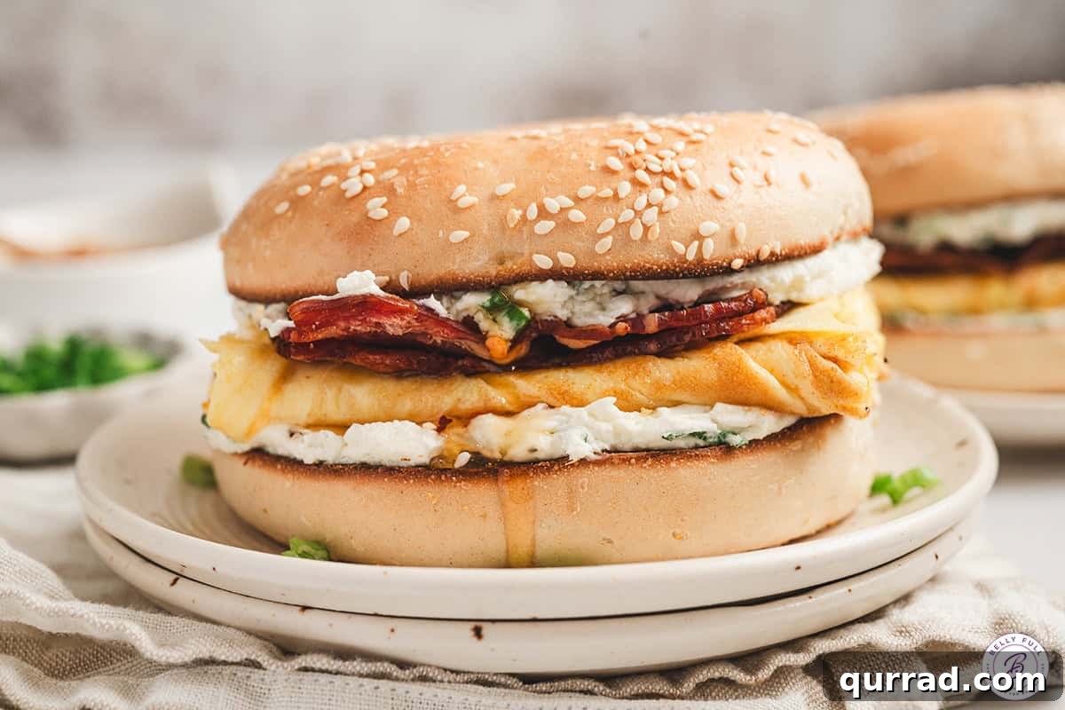 Finished bee sting bagel breakfast sandwich served on a plate with sweet and savory layers visible