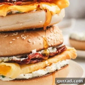 Bee sting bagel stacked with bacon, creamy eggs, jalapeño cream cheese, and melted cheese, drizzled with hot honey
